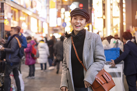 美丽的微笑着笑容的女游客在街上行走人群购物市中心商店情绪女性乐趣街道女孩情感图片