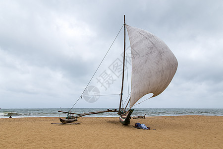 斯里兰卡Negombo海滩上的传统动物园旅游钓鱼吸引力水手渔夫双体海洋支撑海岸男人图片