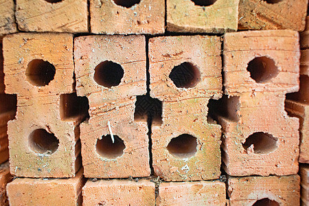 橙色砖用于建筑材料 层层叠叠黏土风化技术砖块正方形建造水泥石头建筑材料背景图片