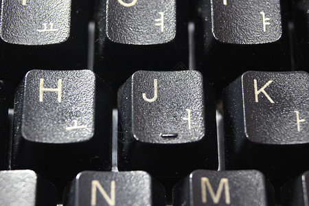 带有白色字母和数字的膝上型计算机键盘黑键的特写宏观电子技术按钮电脑木板笔记本按键桌面塑料图片