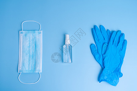 一套个人卫生用品 来自蓝色背景的医疗面罩 手套和消毒器 COVID19大流行病CUVID19防腐剂酒精细菌凝胶工具外科医院药品流图片