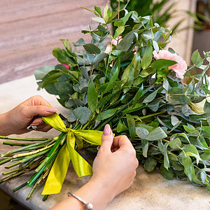 花女在店里做花花束花朵女人雏菊植物群向日葵店铺玫瑰剪刀郁金香成人图片