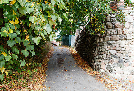 城市街道上的旧石墙房子石膏栅栏水泥白色岩石风化绿色乡村石头图片