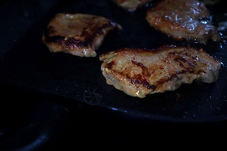 黑煎锅上的鸡肉鱼片迷迭香木头油炸家禽吃饭美食黑色健康饮食香料图片