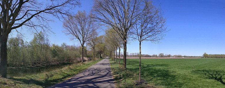 通往Veldhoek的道路蓝天阴影晴天全景运河图片