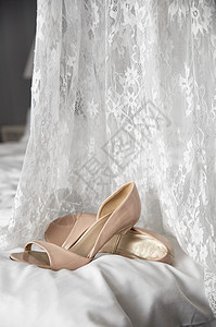衣服旁边床边的婚礼鞋蕾丝新娘窗帘奢华婚礼女孩房间装饰衣架花束图片