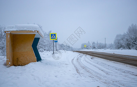 有立交桥的乡村公路 泥雪特写中的汽车轨道 在多云的冬日的森林道路 从公共汽车站看到的景色 运输 危险驾驶 冬季轮胎 偏远地区图片
