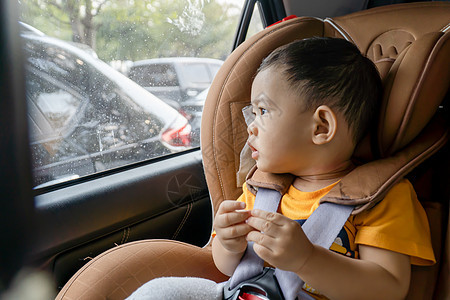 在车上的座椅上贴近了小男孩腰带车辆男性窗户汽车男生旅行幸福家庭婴儿图片