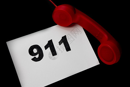 拨打911和紧急呼叫概念 文本911在纸上和电话隔离在黑色医院屏幕数字手机记忆固定电话警报救援帮助安全图片