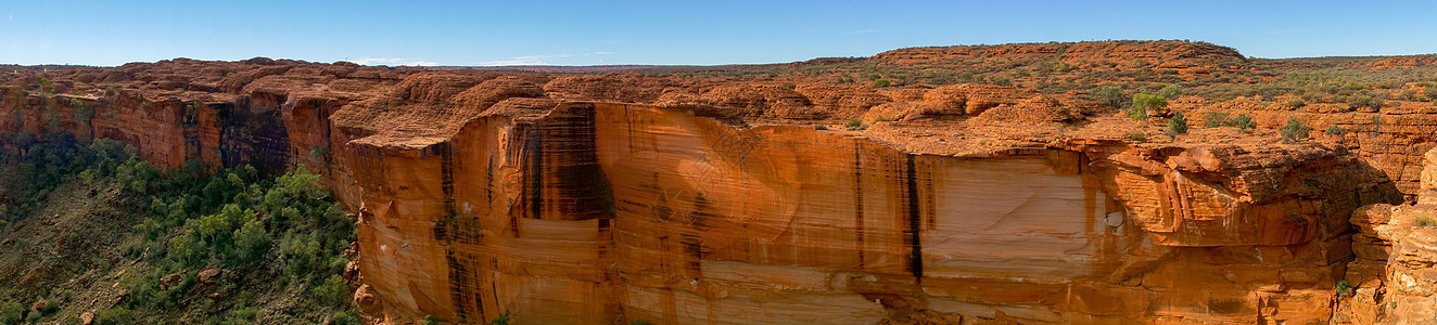 澳大利亚北区Watarka国家公园峡谷墙的视图 澳大利亚北方领土巨石悬崖沙漠中心天空橙子地质学蓝色土著侵蚀图片