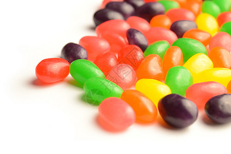 Jelly Bean 角扩散甜点白色团体食物混合物诱惑传播味道乐趣小吃背景图片