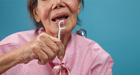 护理员在使用牙科霜棒时照顾年长的老年妇女退休祖母牙刷牙线牙齿微笑口腔护理保健幸福图片