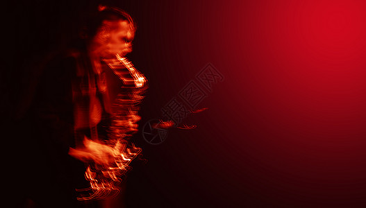 Saxphone 播放器的抽象图像音乐会独奏者展示辉光红色线条演员舞台运动居住图片