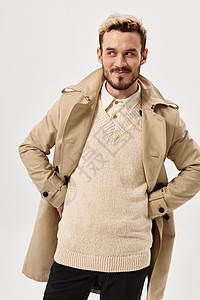 男人穿着米色大衣秋天风格 将孤立的背景抛在一旁图片