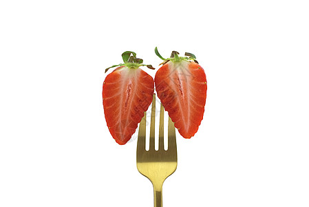两半半的半切草莓 夹在叉子上高清图片