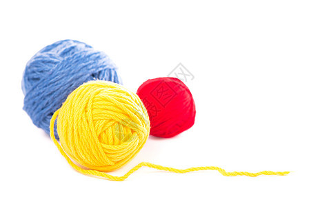 白色背景上的蓝色和黄色羊毛线球爱好缝纫棉布针线活针织衣服编织材料圆圈工艺图片