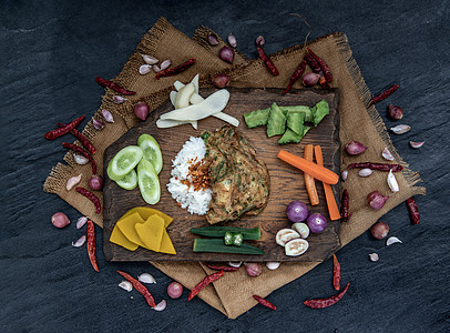 当地泰国食品风格的煎蛋或茉莉米上的热蛋 其配料和新鲜蔬菜在木制背景上油炸盘子羽状烹饪食物蒜瓣美食午餐猪肉噼啪图片