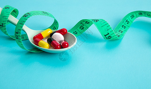 计量胶带和药丸的饮食概念药品营养食物重量刀具卫生减肥节食测量损失图片