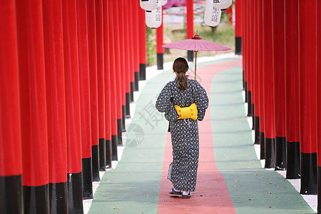 穿着和服的女人拿着伞走进来 在圣殿红门 在日本花园建筑学传统隧道寺庙戏服女士女孩旅游裙子宗教图片