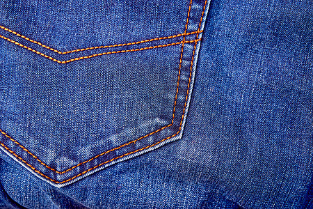 Blue denim牛仔裤背景口袋 缝合和橙色线缝合裤子宏观喘气衣服纺织品画幅工业棉布织物接缝图片