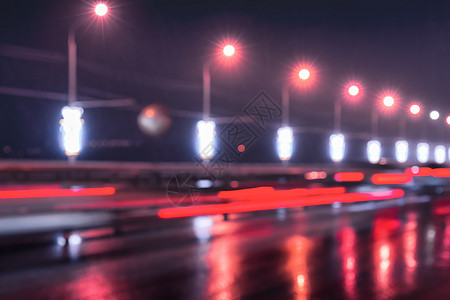 汽车和灯笼的闪亮灯光照耀着夜间城市湿沥青运动运输场景景观反射交通路灯街道耀斑夜生活图片