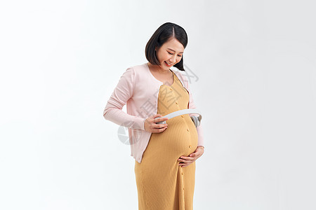 肚子上戴耳机的孕妇怀孕婴儿女士母性父母技术腹部成人母亲音乐图片
