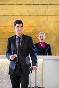 提供钥匙卡的男子在旅馆接待员检查客人商务办公室工作商业卡片前台女士接待人士图片