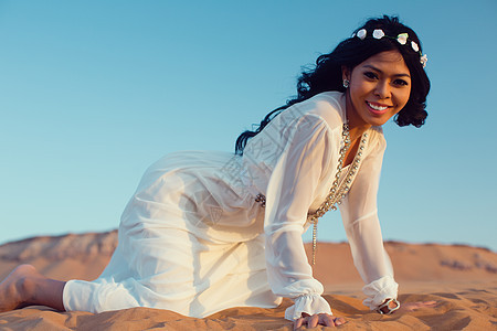在阿拉伯沙漠度假的旅游女游客图片