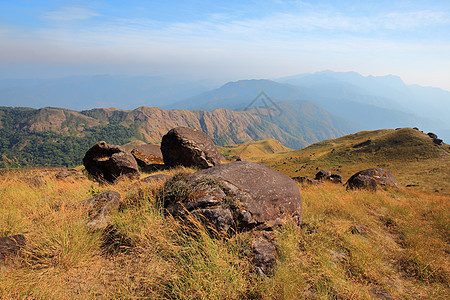 晚上山上的草地是阳光明媚的晴天山脉背景农村国家旅行风景远足岩石季节图片