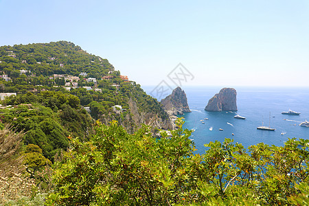 意大利卡普里岛的景色在美丽的夏日中 与法拉格里奥尼岩石旅游海景场景游艇晴天石头海岸假期蓝色旅行图片