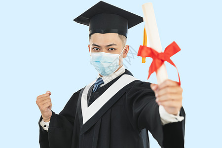 在冠状病毒流行期间 男性青年毕业时佩戴面罩并持有大学证书的年轻男子身着面罩疾病面具文凭男人砂浆教育学校口罩学生感染图片