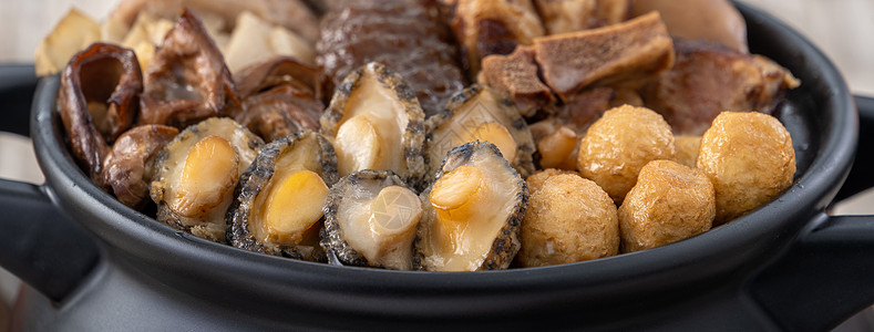 近距离接近的中国传统食物叫做福岛强黄瓜盘子鲍鱼佛跳墙肠子木头烹饪油炸猪肉海鲜图片
