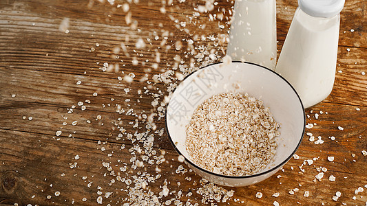 白碗中的Oat薄片和鲜奶瓶谷物种子饮食水壶木板燕麦早餐食物小吃农业图片