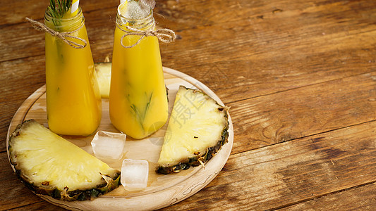 新制菠萝果汁 冰装在小玻璃瓶里 在木本底浆果稻草玻璃凤梨柠檬覆盆子橙子食物酸奶热带图片