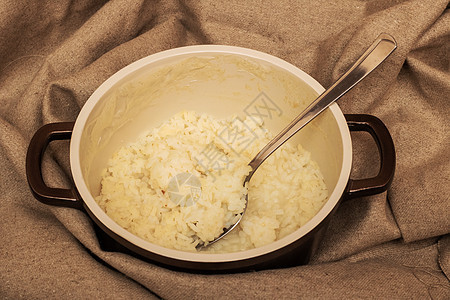 大米粥和汤匙 放在布上美食乡村灰色午餐饮食勺子早餐甜点橙子营养图片
