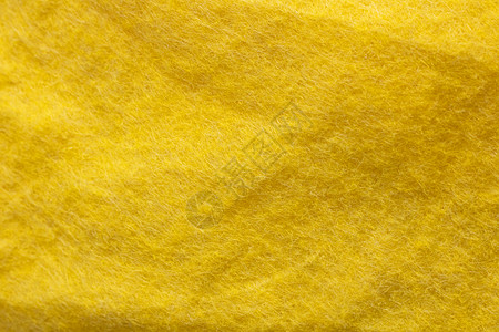 黄色皱褶织物特写背景和纹理背景图片