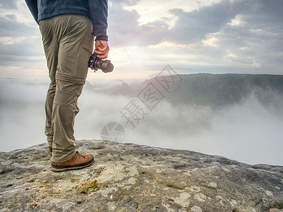 手拿着照相机的Landscape摄影师 人爬上去了背包悬崖风光记忆岩石作品电话摄影相机风景图片