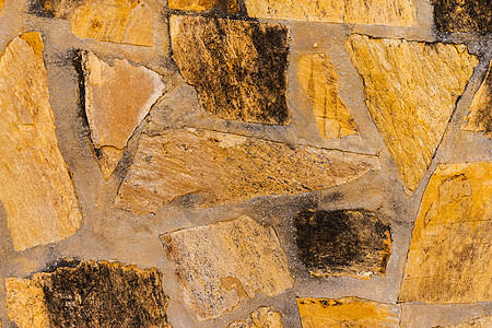 放在墙上的旧石头有趣而原始的背景侵蚀大理石崎岖水泥墙纸建筑学石工石墙裂缝花岗岩图片