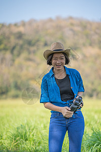 妇女戴帽子 在草地佩戴望远镜女孩天空野生动物旅游农村双目女性荒野间谍监视图片