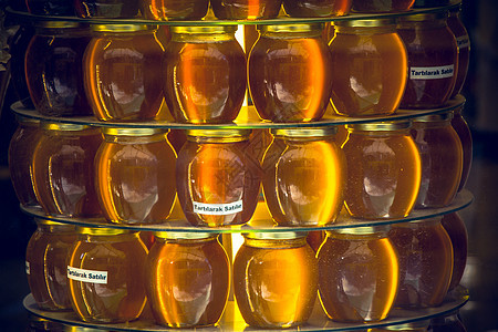 蜂蜜罐 作为美味的养分成分蜜蜂蜂巢六边形蜂窝蜂蜜金子甜点食物液体宏观图片