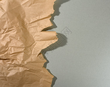 薄荷棕色纸 边缘撕裂 灰色背景上有阴影  designe 的抽象创意背景羊皮纸包装工艺包装纸床单剪贴簿横幅损害折痕皱纹图片