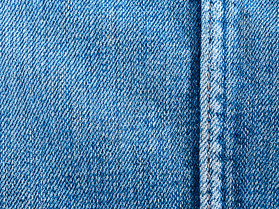 牛仔面料的质地和接缝裤子时尚衣服服装牛仔布纺织品蓝色织物背景图片
