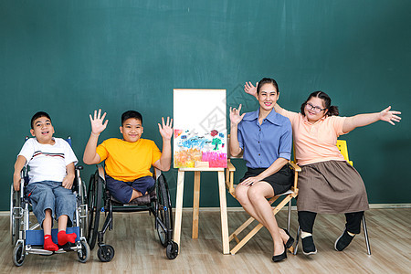 一组残疾和自闭症的年轻女孩正在通过用水绘画和油漆来训练她们的手和手指肌肉 a 教育学校幼儿园喜悦童年生活幸福乐趣人士艺术家创造力图片
