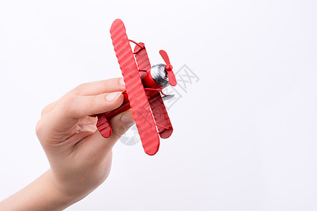 手持白色背景的玩具飞机Name航班乘客旅行车辆商业航空公司喷射运输世界背景图片