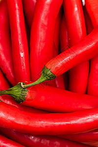 炽热的辣椒起来 红辣椒的背景调味品厨房植物燃烧寒冷烹饪红色蔬菜香料美食图片