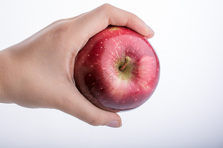 握着苹果的小小孩手水果白色食物绿色红色饮食图片