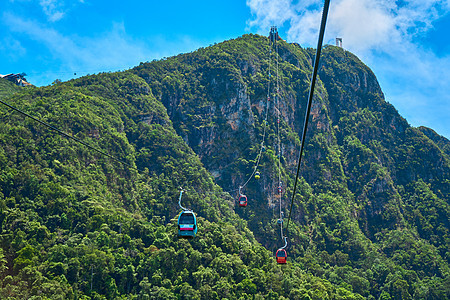 从一辆有电缆的汽车上看到 高高飞向热带岛兰卡维山丘 不可思议的自然景观缆车天空爬坡玻璃高度全景顶峰吸引力娱乐海洋图片