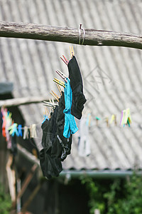挂在户外绳索上的彩色衣物衣夹家务别针洗涤剂衣服纺织品蓝色衬衫天空织物图片