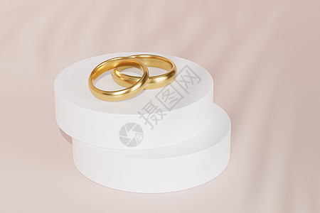 白色讲台或基座米色背景上的两个金色结婚戒指 带有叶影 3d rende图片