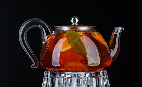 在透明的茶壶里泡薄茶早餐水果背光叶子薄荷草本玻璃杯子食物草本植物图片